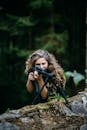 Woman With Long Curly Hair Winking on a Firearm