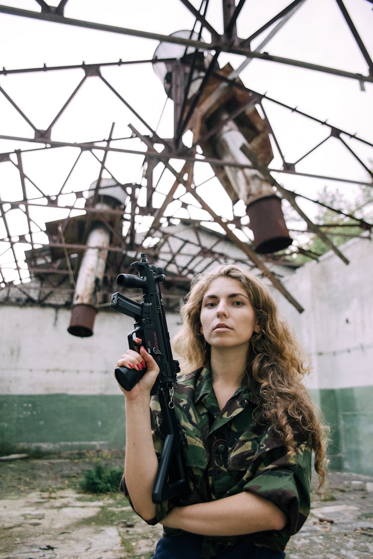 Woman Holding A Machine Gun In A Military Jacket 