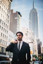 Man in Black Suit Jacket Holding Smartphone