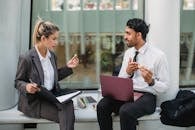 Businessman and Businesswoman Talking during Lunch Break