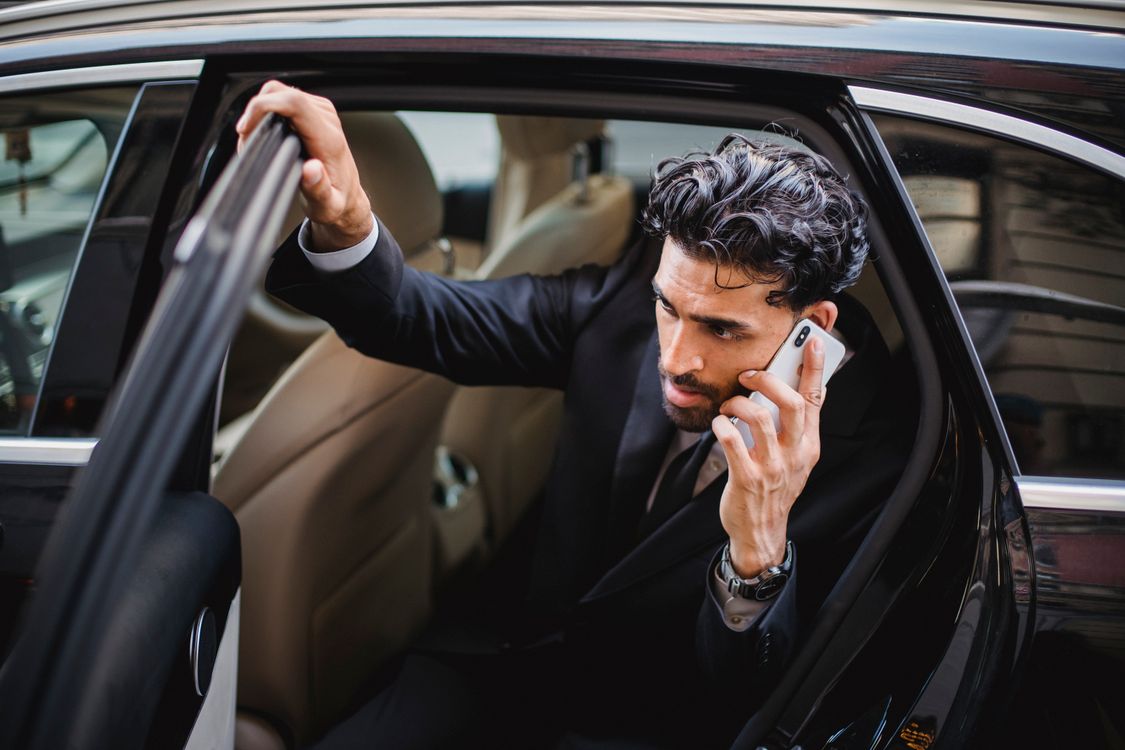 A Man in a Phone Call Getting out of a Car · Free Stock Photo