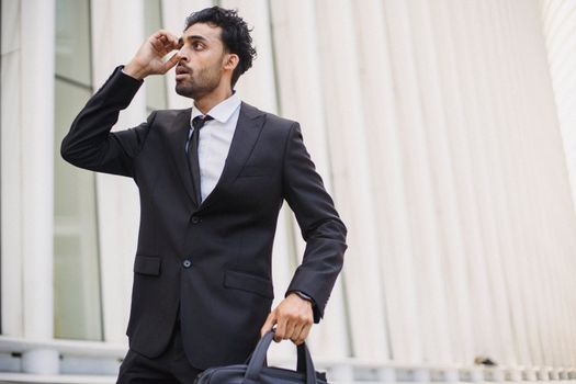 
A Man in a Suit Holding a Briefcase
