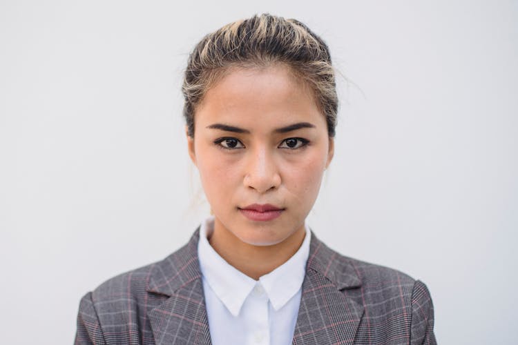 
A Portrait Of A Woman In A Plaid Suit