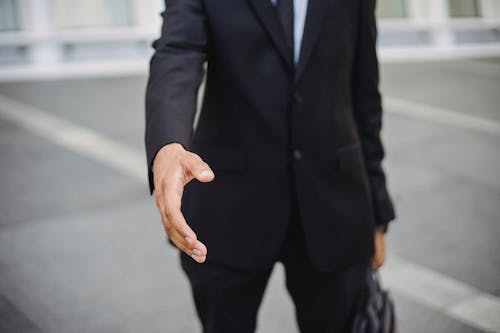 

A Man in a Suit with His Hand Out for a Handshake
