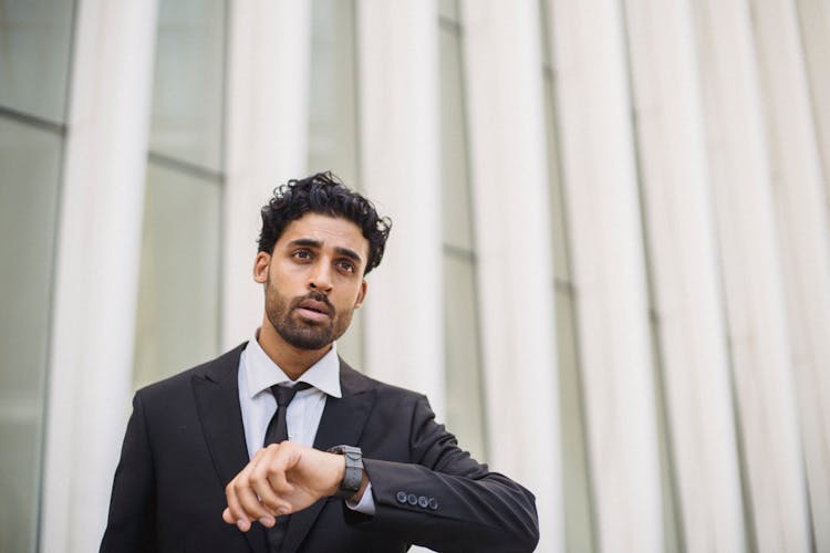 
A Bearded Man In A Suit Wearing A Watch