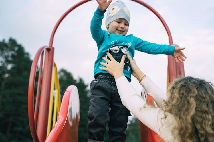 Mother With Child On Playground