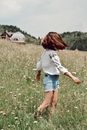 Young woman walking in blooming field