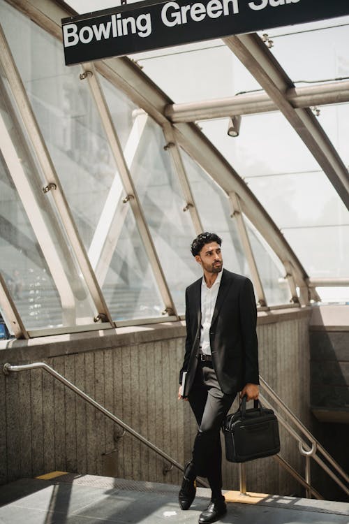 Man in Black Suit Carrying His Black Laptop Briefcase