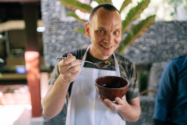 Smiling Man Holding Bowl And Spoon