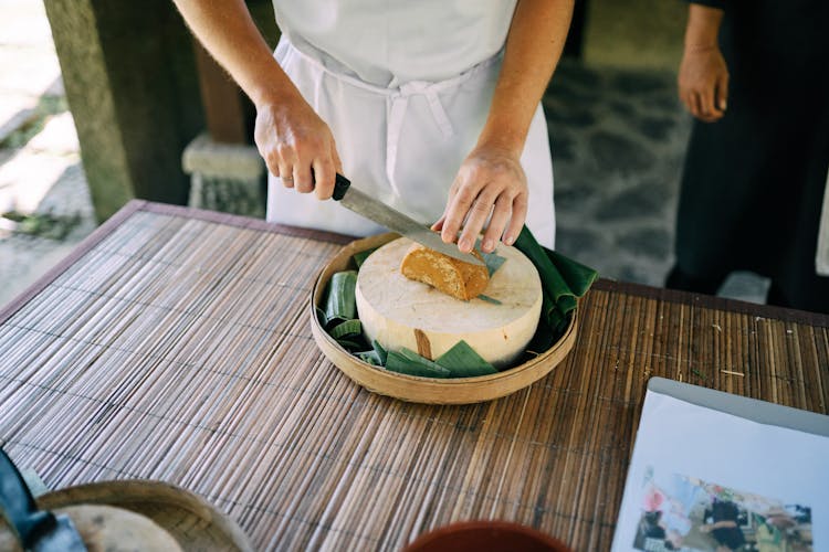 Hands Cutting Bread