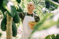 Man in White Thobe Standing Near Green Banana Plant