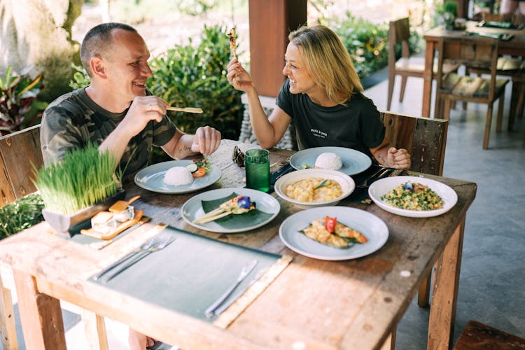 A Man And A Woman Sitting At A Restaurant