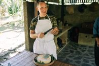 Man Standing with Knife over Cheese