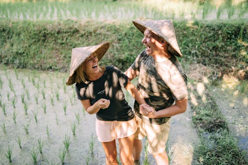 Smiling Couple Standing on Rice Field