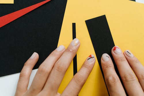 Free Persons Hand on Yellow and Black Textile Stock Photo