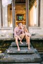 Couple Sitting on the Stairs of a Hut on Vacation 