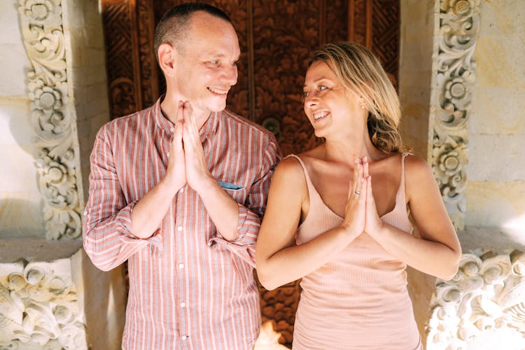 Couple In Praying Pose Smiling