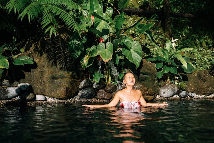 Happy Woman Swimming In Tropical Lake