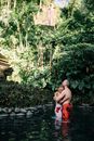 Woman in Red Tube Dress Standing Near Green Trees