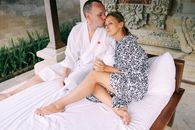 Couple Sitting in Bed Embracing