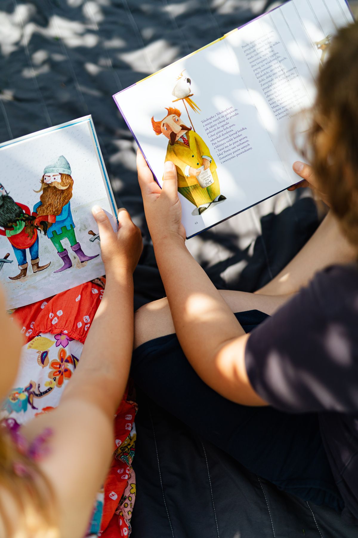 Thanksgiving kids table ideas with children reading a picture storybook at a table