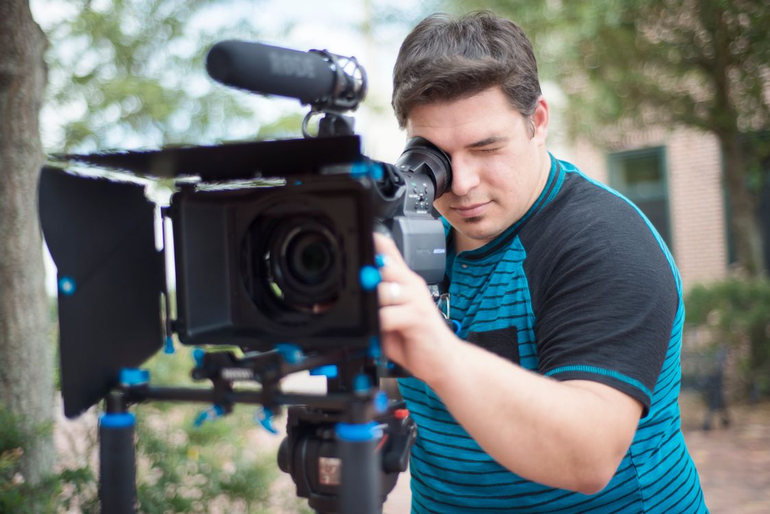 Somone Using Camera A Man Using a Video Camera · Free Stock Photo