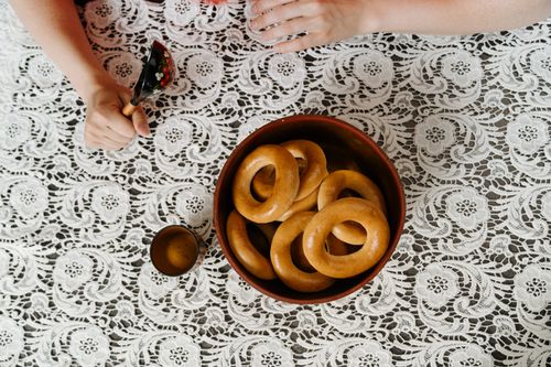 Free Overhead view of baranka in a bowl on a lace tablecloth, part of a traditional Russian tea setup. Stock Photo