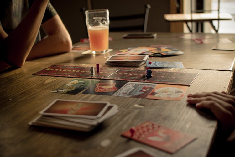 Close-up Of People Playing Board Game