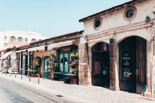 Free Explore a quaint street in the old town featuring rustic shops and vintage facades. Stock Photo