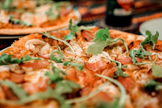 Close-up of a mouthwatering Italian pizza topped with fresh arugula. Perfect for food lovers.