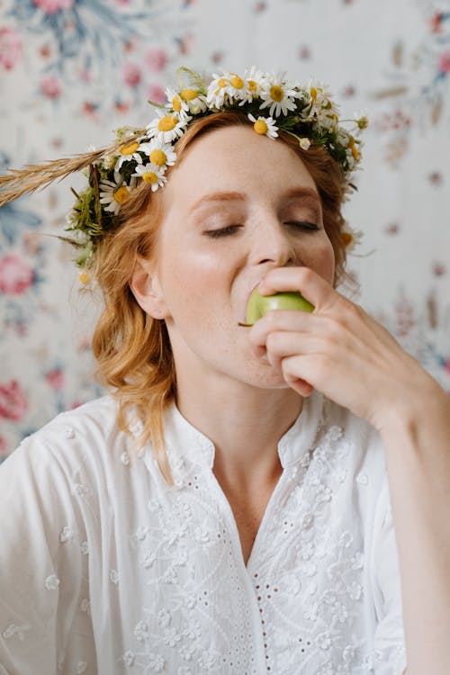 Woman in White Floral Dress With White Floral Headdress