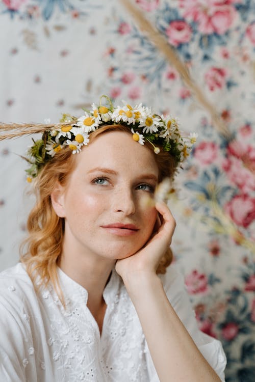Woman in White Shirt With White Floral Headdress