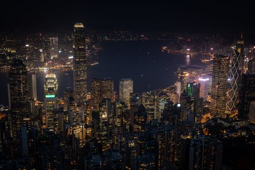 Free Stunning aerial view of Hong Kong's illuminated skyscrapers and vibrant cityscape at night. Stock Photo