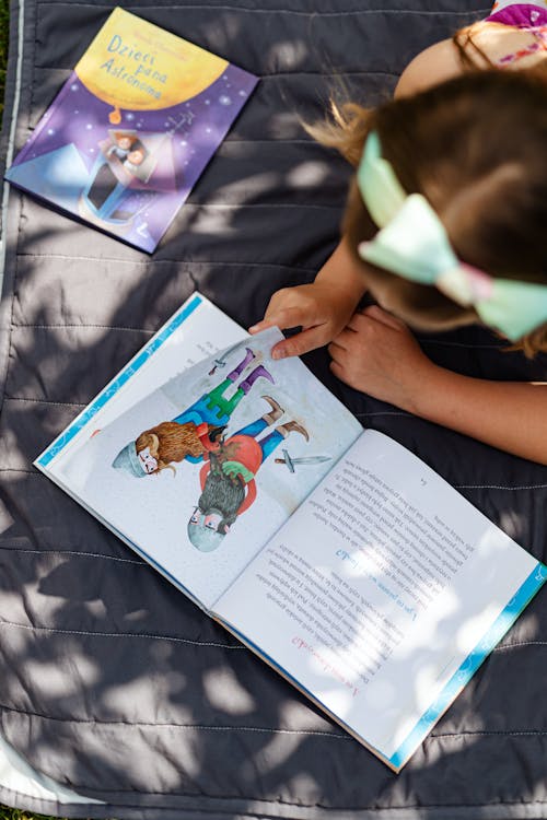 Free Child Reading a Book Stock Photo