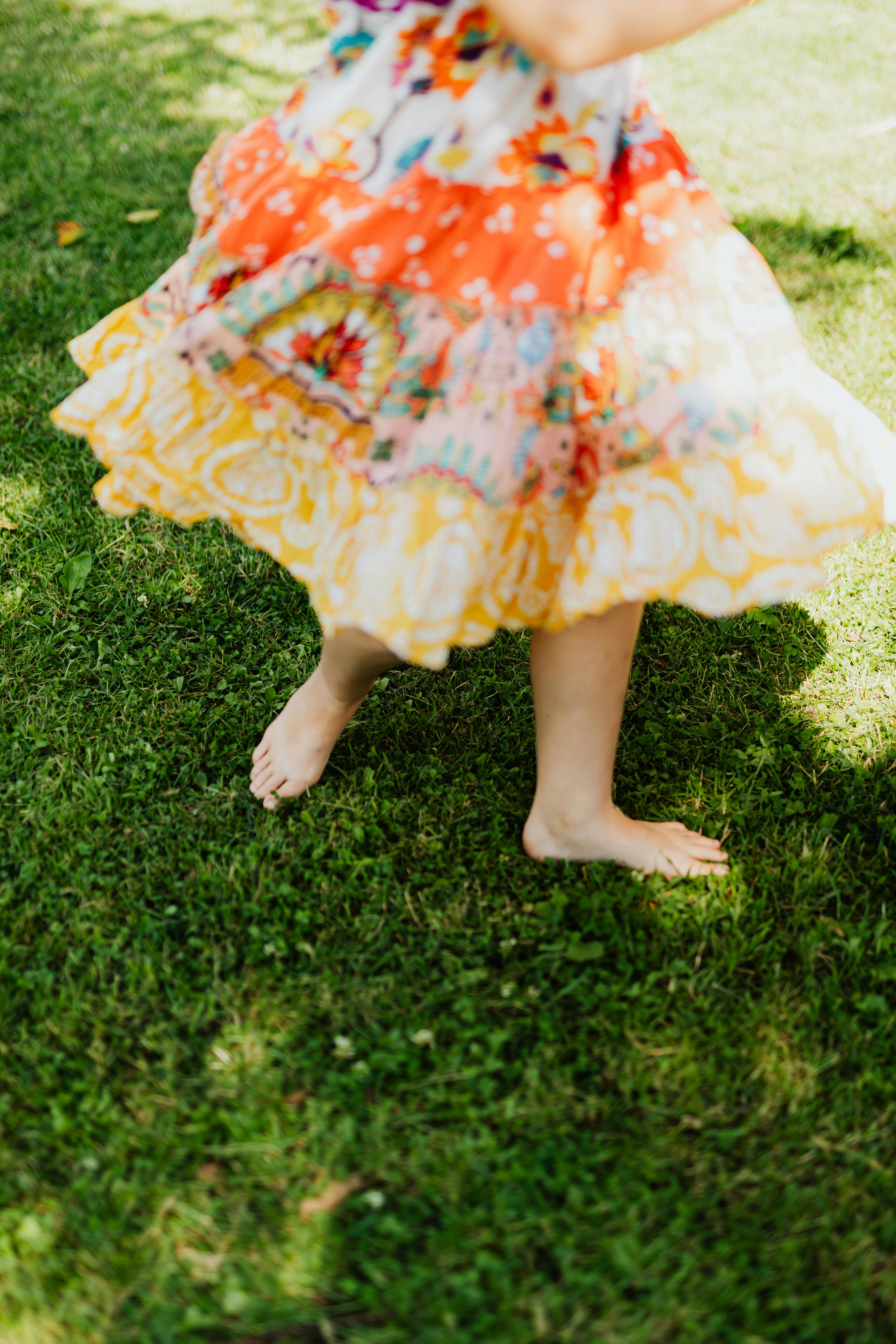 person wearing dress standing on grass