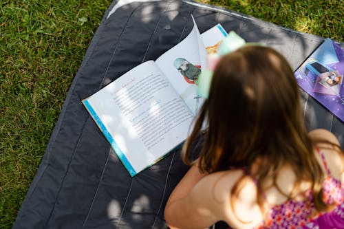 Free Person Lying Down and Reading Stock Photo