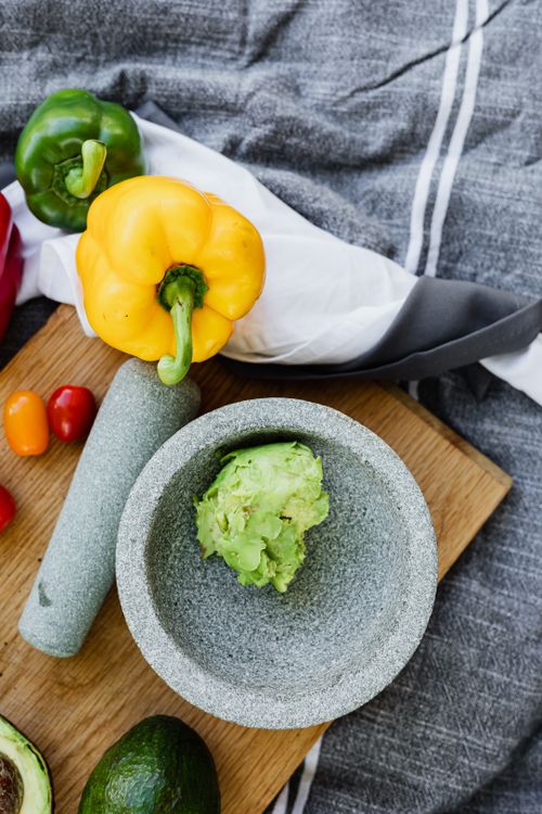 Free A vibrant display of fresh ingredients for homemade guacamole, including avocados and bell peppers. Stock Photo
