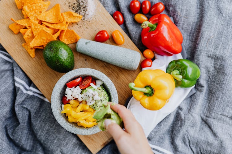 Nachos On Cutting Board With Fruits And Vegetables