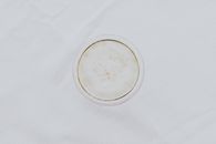 White Round Container on White Textile