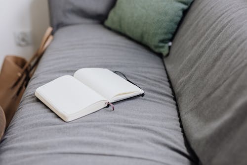 A Blank Notebook on a Couch