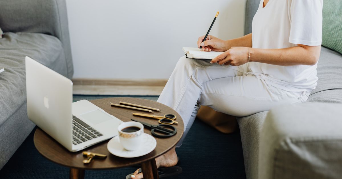 Couch Write Woman in White Shirt Sitting on Couch While Writing on Notebook · Free ...