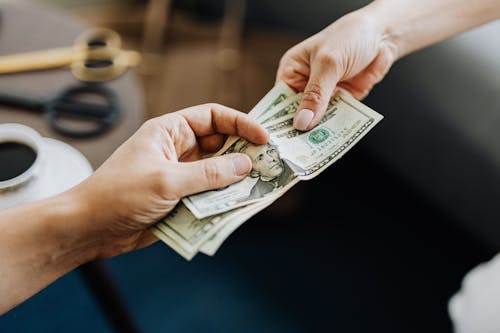 Free Hands Holding Us Dollar Bills Stock Photo