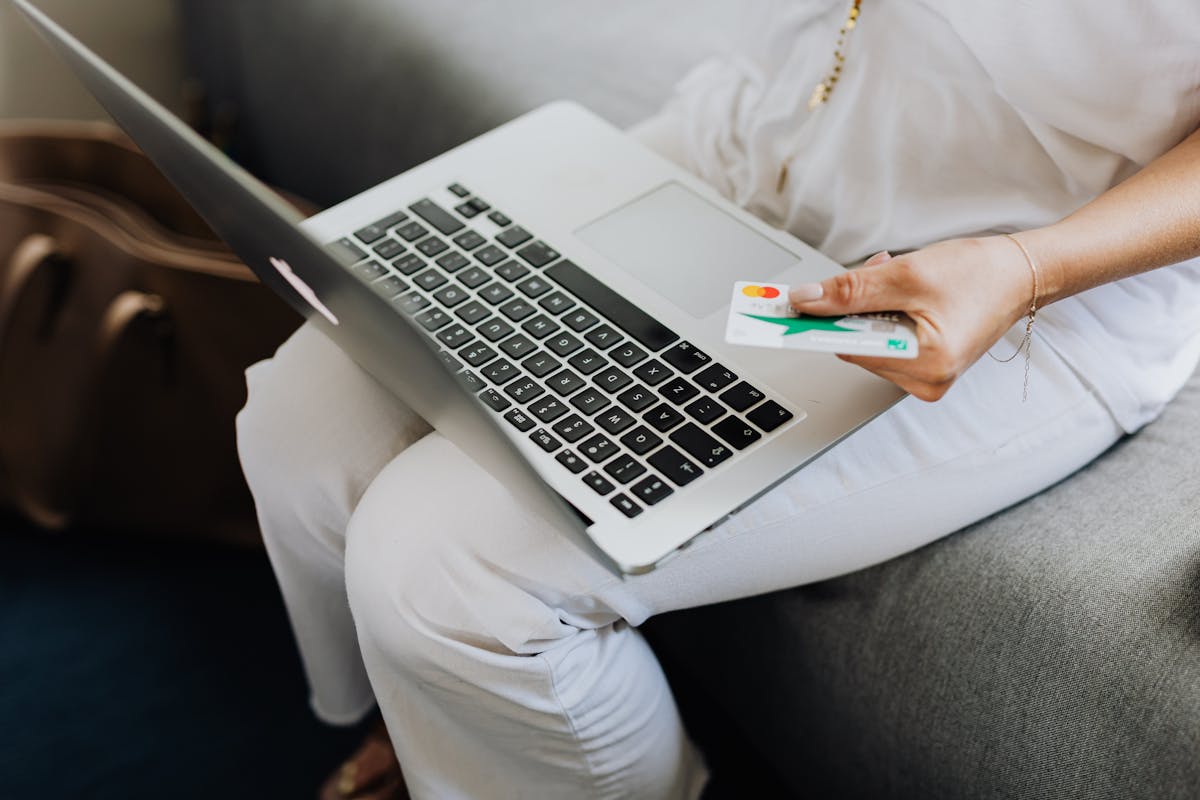 Journalist taking notes while reading information on a laptop screen