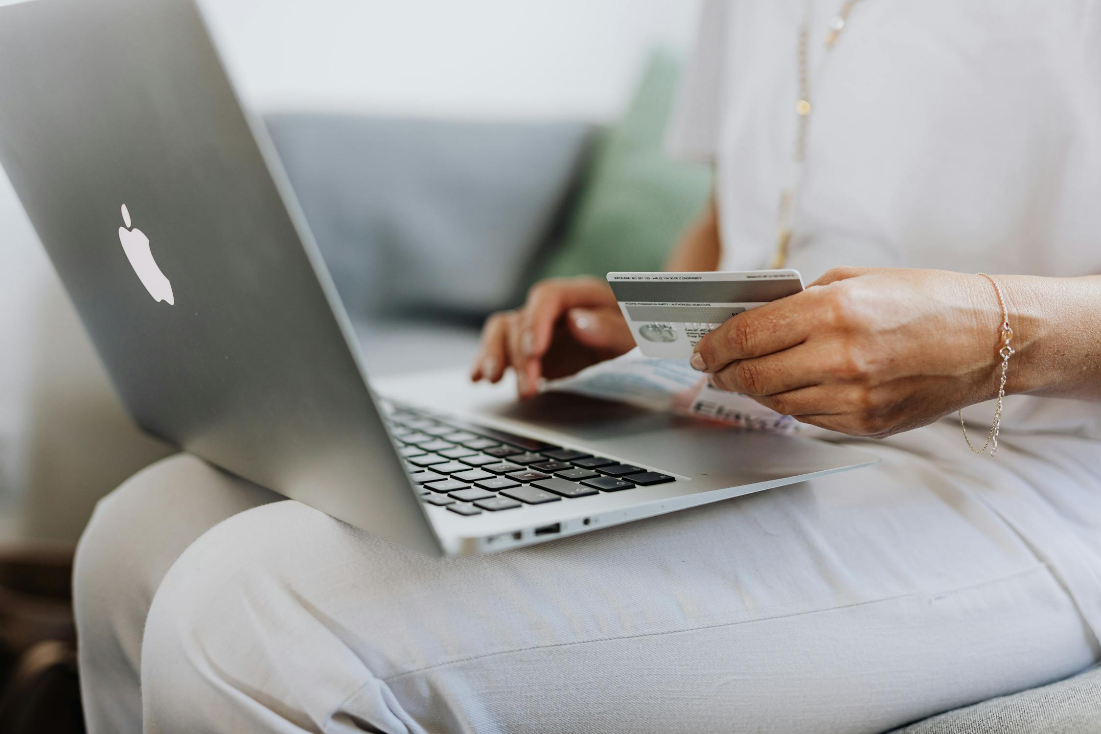 Customer on laptop about to checkout with credit card.