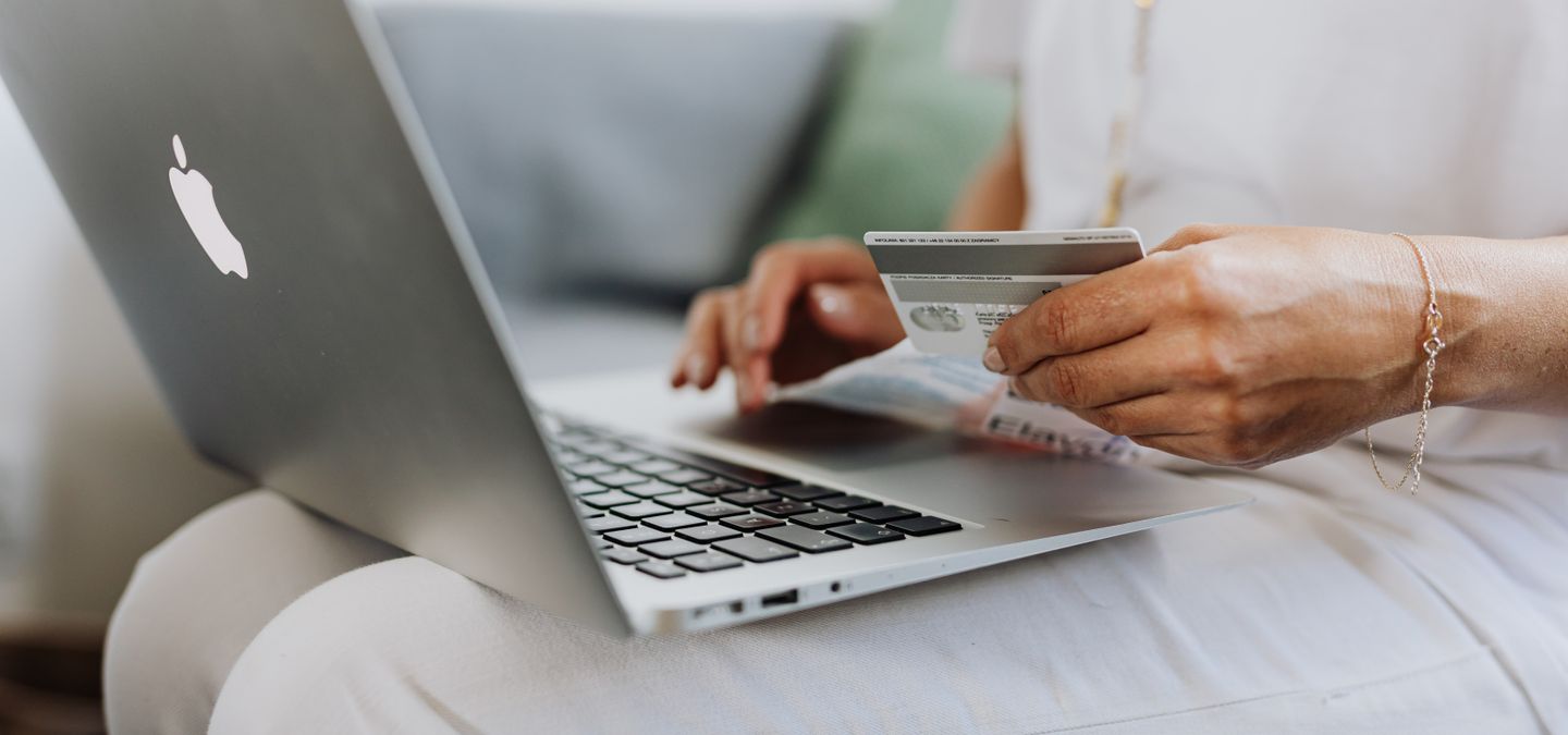Laptop and a payment card on a desk