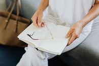 Close-up of Woman Holding Paper Planner