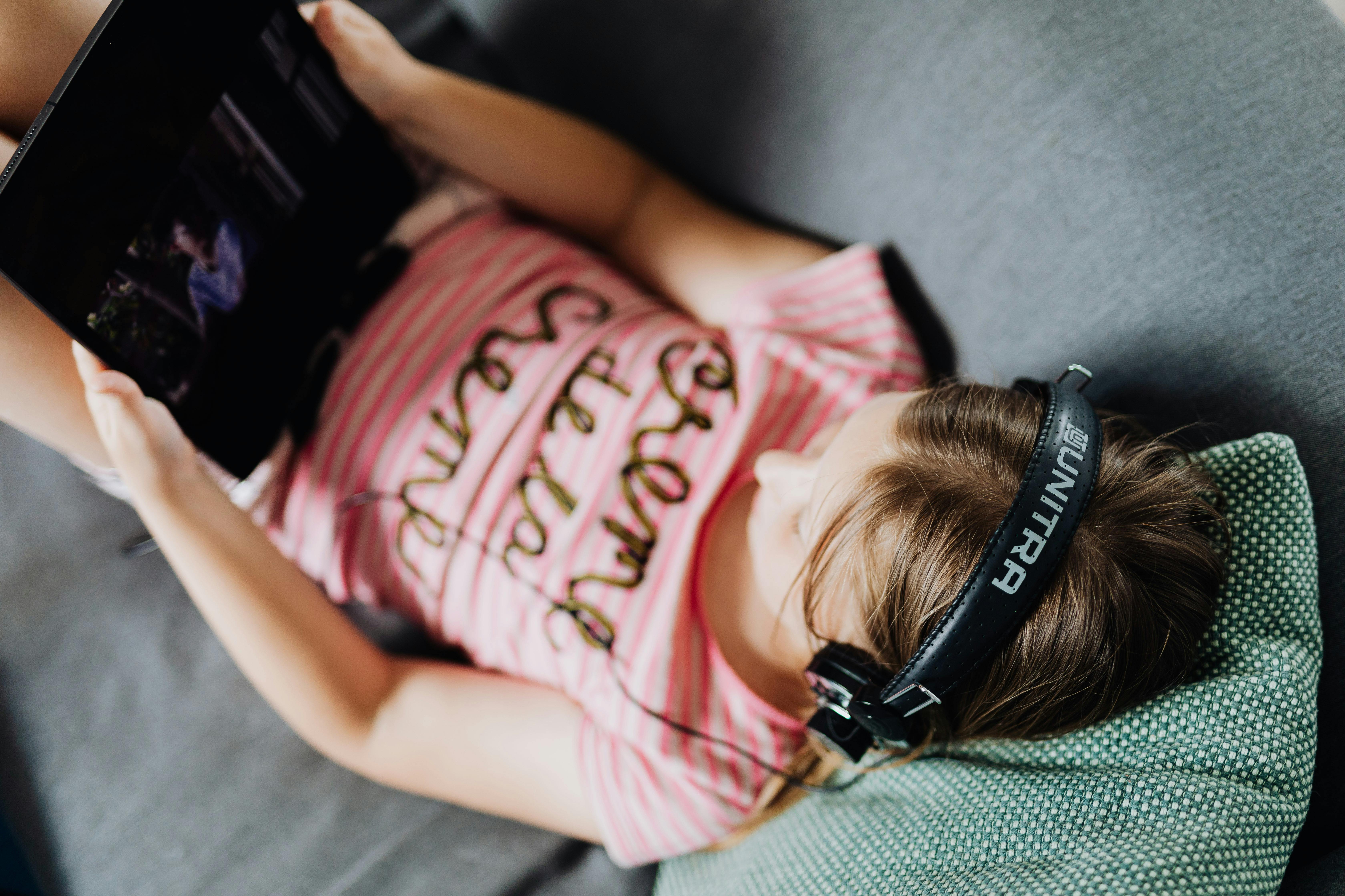 high angle shot of a girl holding her black tablet computer