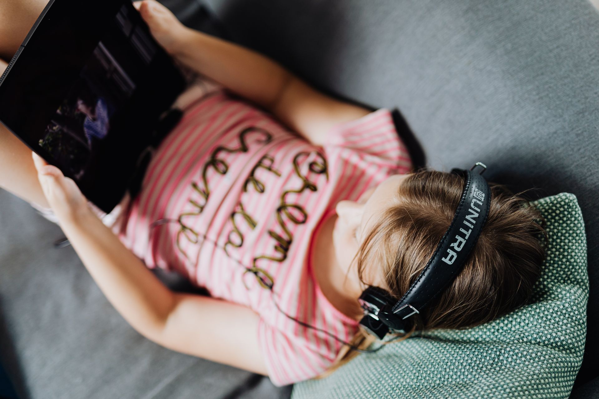 High-Angle Shot of a Girl Holding Her Black Tablet Computer