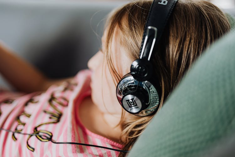 Girl In Modern Headphones Listening To Music