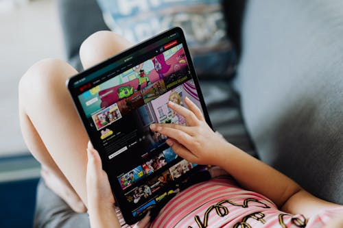 Free Little Girl Holding a Tablet Stock Photo